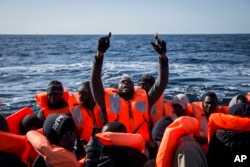 FILE - Sub-Saharan migrants are rescued by members of Proactiva Open Arms NGO at the Mediterranean sea, about 20 miles north of Ra's Tajura, Libya, Jan. 12, 2017. About 300 migrants were rescued Tuesday from three dinghies by members of Proactiva and Italian coast guard.