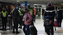 Viajeros llegan al aeropuerto internacional en El Alto, Bolivia, el miércoles 1 de diciembre de 2021, en medio de control policial.