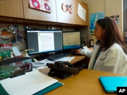 Dr. Mona Hanna-Attisha works at the hospital where more than 2,000 children have been tested for lead since the water switch was made, Jan. 2016. (AP PHOTO)