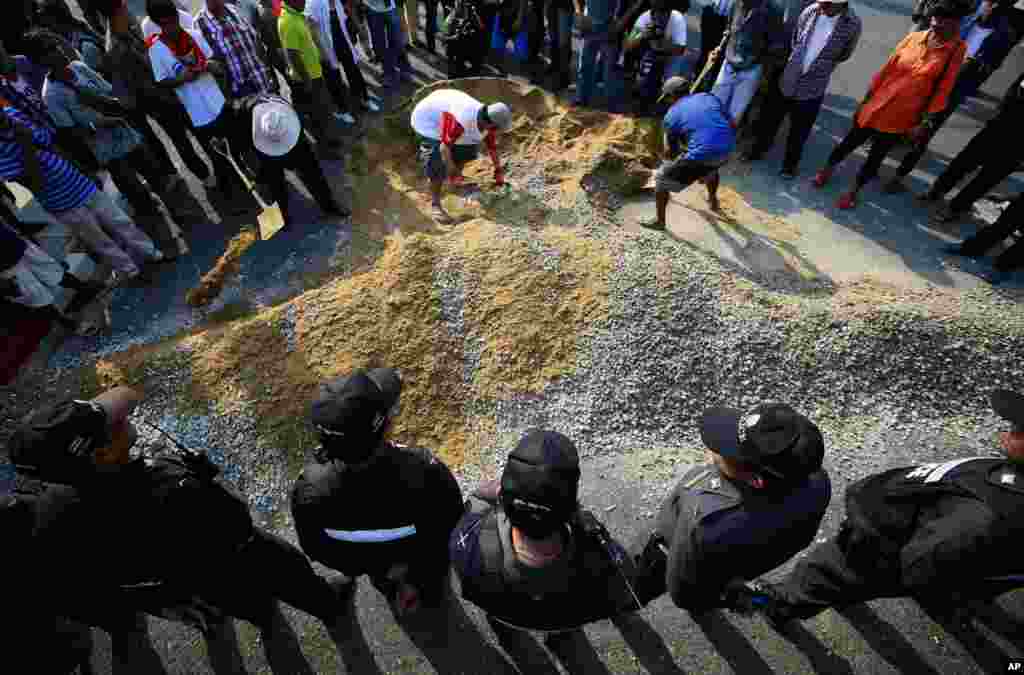 Pro-government supporters protest as they build a barricade to block the gate of National Anti-Corruption Commission office in Bangkok, Feb. 27, 2014.