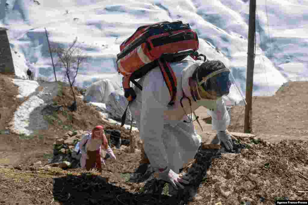 Doctor Akay Kaya (R) and a nurse Yildiz Ayten from the Bahcesaray public hospital arrive in the remote village of Guneyyamac in eastern Turkey, to vaccinate residents aged 65 or over with the Sinovac CoronaVac Covid-19 vaccine, Feb.15, 2021. 