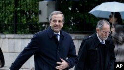 Greece's Prime Minister Antonis Samaras leaves his office for a meeting with Greek President Karolos Papoulias in Athens, Tuesday, Dec. 30, 2014.