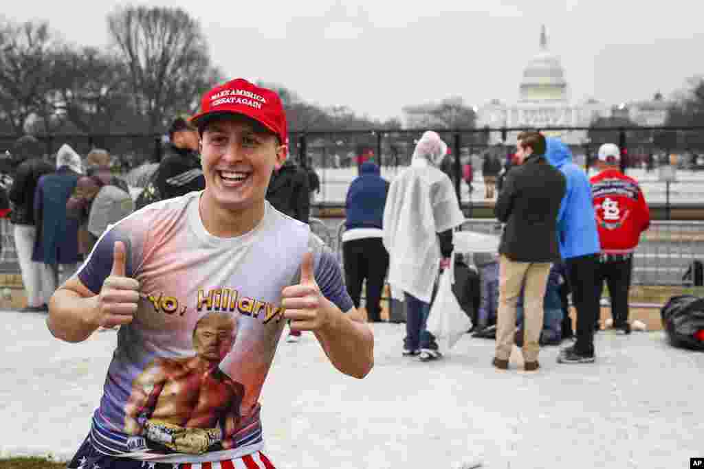 John Watson of Jacksonville, Fla. waits in the rain on the National Mall in Washington, Jan. 20, 2017, before the presidential inauguration of Donald Trump.