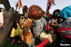 Supporters perform as Sudanese President Omar al-Bashir addresses the crowd during a peace campaign rally in Zalingei in Darfur, April 3, 2016.