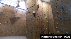 Mariam Shareefy, climbing on the left, practices in a rock-climbing gym in Boulder, Colorado, Aug. 8, 2016.