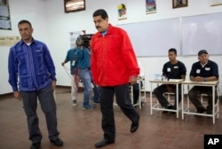 Venezuela's President Nicolas Maduro arrives at a polling station to vote during congressional elections in Caracas, Venezuela, Sunday, Dec. 6, 2015.