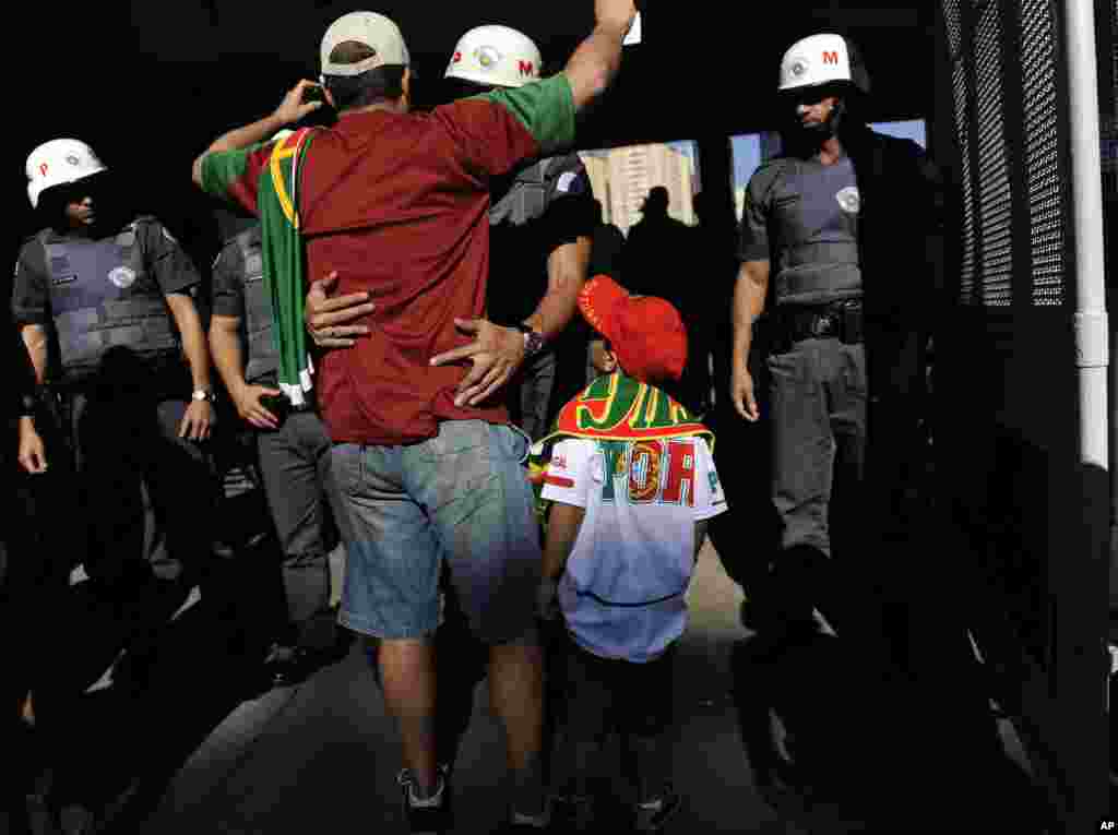 Brazilian police check soccer fans before they go into the stadium to watch Portugal&#39;s training session in Campinas, Brazil, June 18, 2014.