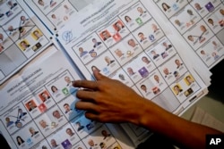 An electoral worker counts ballots at a polling station in Guatemala City, Sept. 6, 2015.