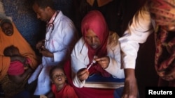 Medical practitioners attend to sick and malnourished children in the drought-stricken Baligubadle village near Hargeisa, the capital city of Somaliland, in this handout picture provided by The International Federation of Red Cross and Red Crescent Societ