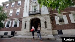 FILE - Students walk into Kirkland House on the campus of Harvard University in Cambridge, Mass.
