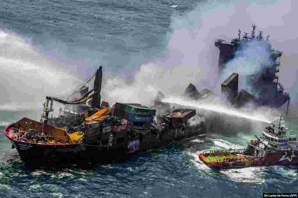 Smoke billow from the Singapore-registered container ship MV X-Press Pearl, which has been burning for the eleventh consecutive day as vessels try to douse off the fire in the sea off Sri Lanka's Colombo Harbor in Colombo.