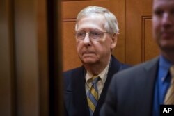 Senate Majority Leader Mitch McConnell, R-Ky., arrives at the Capitol in Washington, Jan. 19, 2018, as a bitterly-divided Congress hurtles toward a government shutdown this weekend.
