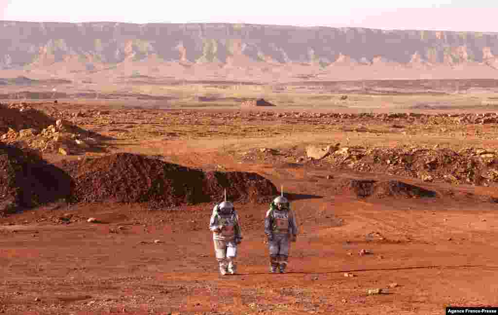 Astronauts from Europe and Israel walk in spacesuits during a training mission for planet Mars at a site that simulates an off-site station at the Ramon Crater in Mitzpe Ramon in Israel&#39;s southern Negev desert, Oct. 10, 2021.