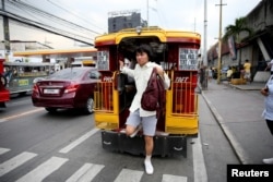 Oliver Emocling, 23, who works for a magazine, gets off a jeepney near his office in Makati City, Philippines, Nov. 29, 2018.