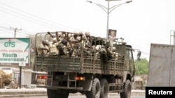 FILE - Soldiers are seen on a truck along a road in Maiduguri in Borno State, Nigeria, May 14, 2015. 