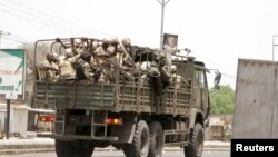 FILE - Soldiers are seen on a truck along a road in Maiduguri in Borno State, Nigeria, May 14, 2015. 