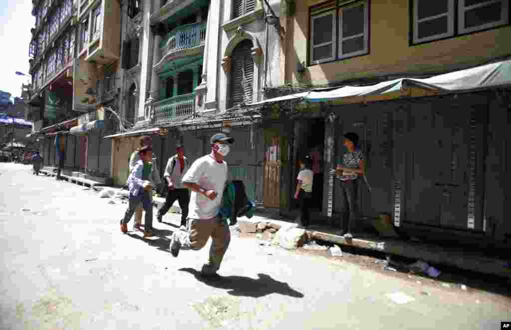 People rush to safety after a powerful earthquake hit Nepal, in Kathmandu, May 12, 2015.