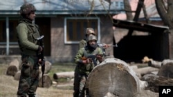 Indian army soldiers stand guard outside an army base where the bodies of suspected rebels are being kept, near the site of a gun battle in Hajin village, north of Srinagar Indian controlled Kashmir, March 22, 2019.