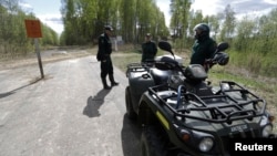 Latvian border guards are seen during a patrol at the EU external border with Russia 