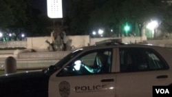 Police officer Monika McCoy does nightly patrols in the same area once covered by her father, and often sees the illuminated tower looming over the University of Texas campus. (G. Flakus/VOA)