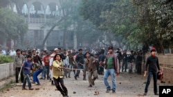 Supporters of the ruling Bangladesh Awami League throw bricks and stones during a clash with the supporters of main opposition Bangladesh Nationalist Party in Dhaka, Dec. 29, 2013. 