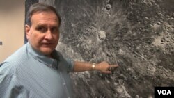 Paul Spudis with a moon mural at the Lunar and Planetary Institute in Houston, Texas. (G. Flakus/VOA)