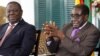 Presidente Robert Mugabe (à direita) e o primeiro-ministro Morgan Tsvangirai (à esquerda) do Zimbabué