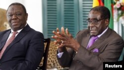 Zimbabwean President Robert Mugabe (R) and Prime Minister Morgan Tsvangirai address a media conference at State House in Harare, January 17, 2013.