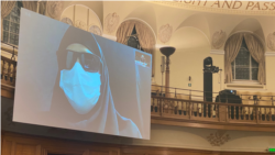 An Iranian woman with her face disguised to conceal her identify gives live video testimony from Iran on Nov. 10, 2021, to a London-based international people's tribunal investigating alleged atrocities in Iran's deadly crackdown on nationwide protests in Nov. 2019. (VOA Persian/Ramin Haghjoo)