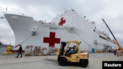 FILE - Supplies are loaded into the San Diego-based hospital ship USNS Mercy as it prepares for possible deployment to aid the typhoon-stricken areas of the Philippines from its port in San Diego, California, Nov. 15, 2013. 