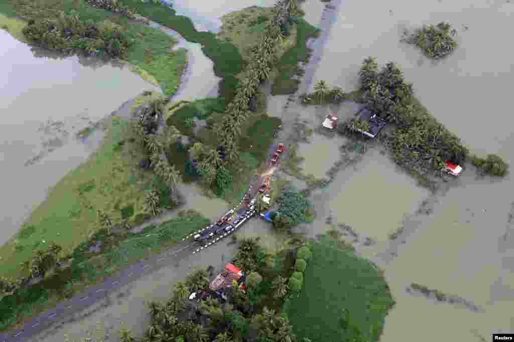 An aerial view shows partially submerged road at a flooded area in the southern state of Kerala, India, Aug. 19, 2018.