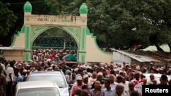 FILE - Muslims faithfuls carry a coffin with the body of Sheikh Mohammed Idris, chairman of the Council of Imams and Preachers of Kenya (CIPK), who was gunned down by assailants near his home in Mombasa, June 10, 2014.