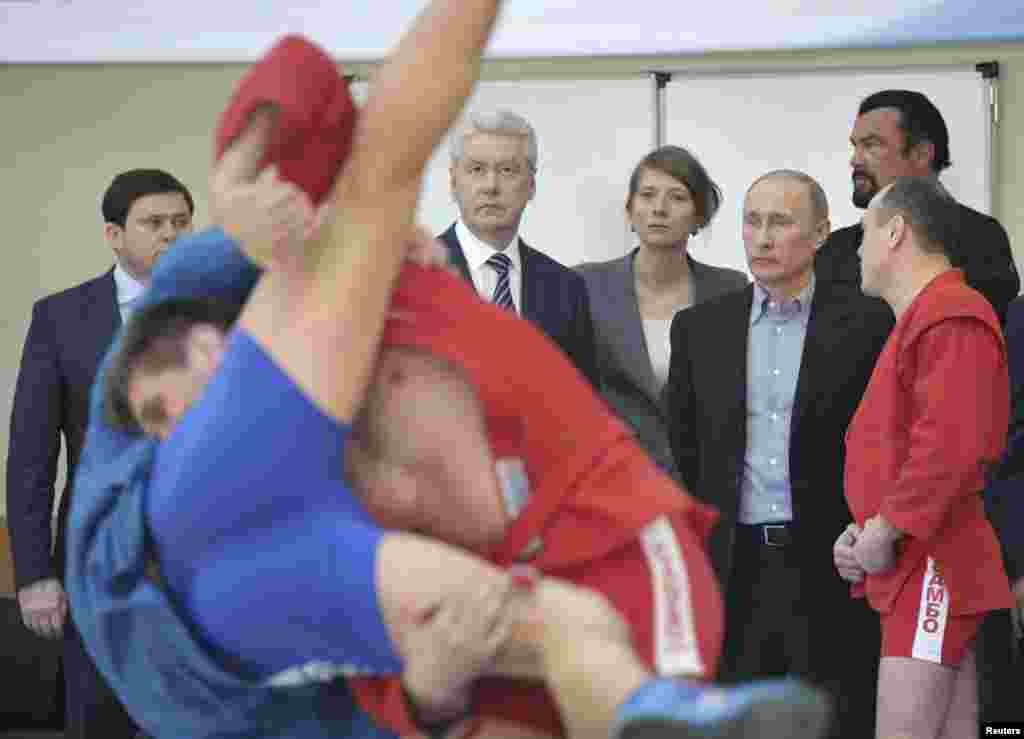 Russian President Vladimir Putin (2nd R), Mayor of Moscow Sergei Sobyanin (2nd L, back) and actor Steven Seagal (R, back) visit a new sports arena on the territory of the Sambo-70 training sports complex in Moscow.