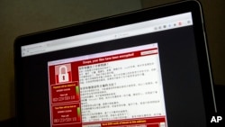 A screenshot of the warning screen from a purported ransomware attack, as captured by a computer user in Taiwan, is seen on laptop in Beijing, May 13, 2017.