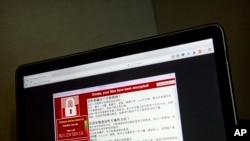 A screenshot of the warning screen from a purported ransomware attack, as captured by a computer user in Taiwan, is seen on laptop in Beijing, May 13, 2017.