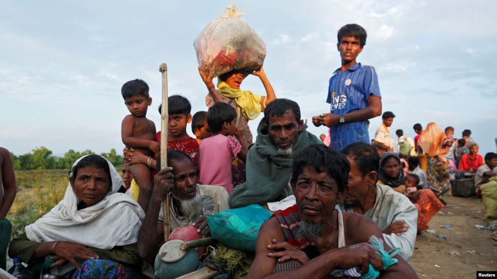 Exhausted Rohingya refugees wait to be taken to a refugee camp after crossing the Naf river at the Bangladesh-Myanmar border in Palang Khali, near Cox’s Bazar, Bangladesh, Nov. 2, 2017.