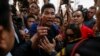 Protesters demanding the right to vote argue with security and election officials at a Din Daeng district office where voting was called off in Bangkok, Feb. 2, 2014.