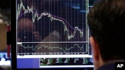 A specialist looks at a screen at his post on the floor of the New York Stock Exchange, Oct. 2, 2013. 