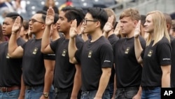 FILE - New Army recruits take part in a swearing in ceremony before a baseball game between the San Diego Padres and the Colorado Rockies in San Diego, June 4, 2017.