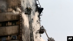 On Thursday, Iranian firefighters worked to extinguish the blaze the Plasco building before it collapsed, Jan. 19, 2017.
