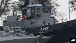 FILE - The damage on one of three Ukrainian ships is seen after it had been seized, Nov. 25, 2018, in Kerch, Crimea.