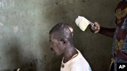 A nurse dresses the machete wounds on the head of Jean-Marie Anigbishe, 45, who was attacked by Ugandan Lord's Resistance Army (LRA) rebels near Ngalima in northeastern Congo. (File Photo)