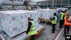 FILE - Officials receive boxes of Moderna coronavirus vaccine at the airport in Nairobi, Kenya, Sept. 6, 2021. 