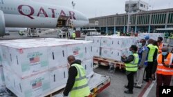 FILE - Officials receive boxes of Moderna coronavirus vaccine at the airport in Nairobi, Kenya, Sept. 6, 2021. 