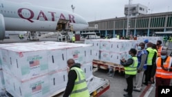 Officials receive boxes of Moderna coronavirus vaccine at the airport in Nairobi, Kenya, Sept. 6, 2021. 