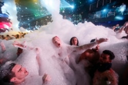 Spring Breakers are covered in foam at The City nightclub in the city of Cancun, Mexico, early Monday, March 16, 2015. Cancun continues to be one of the top foreign destinations for U.S. college students to spend Spring Break. (AP Photo)