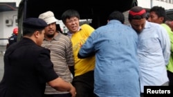 2011 FILE: Police detain opposition Parti Keadilan Rakyat (PKR) MP Tian Chua (3rd L in yellow) and supporters of the "Bersih" (Clean) electoral reform coalition during a rally in Kuala Lumpur, Malaysia.
