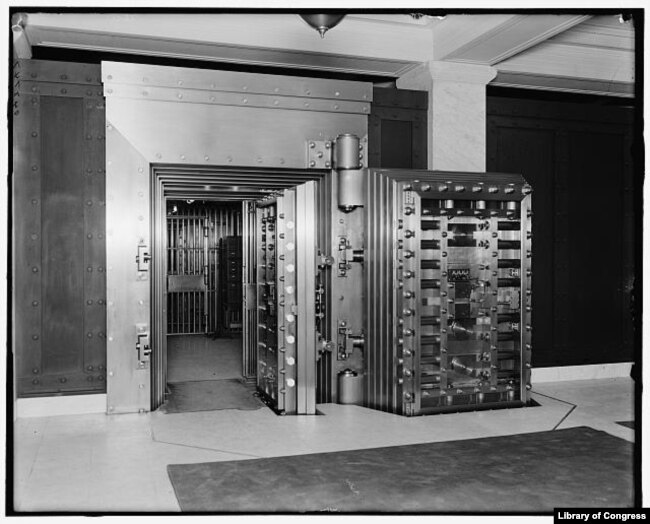 FILE - Twenty-five-ton door, safe deposit vault, main office, Old Colony Trust Company, Boston, Mass.