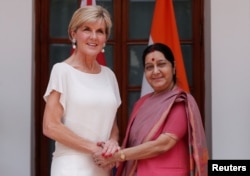 Australian Foreign Minister Julie Bishop shakes hands with her Indian counterpart Sushma Swaraj (R) during a photo opportunity ahead of their meeting at Hyderabad House in New Delhi, India, July 18, 2017.