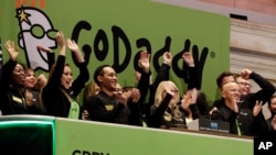 GoDaddy CEO Blake Irving joins the celebration during New York Stock Exchange opening bell ceremonies for his company's IPO, April 1, 2015. GoDaddy is one of the internet companies to begin to police hate speech online.